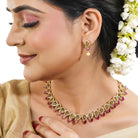 Vibrant multicolor stone-studded goldtone necklace set with matching earrings for festive elegance.
