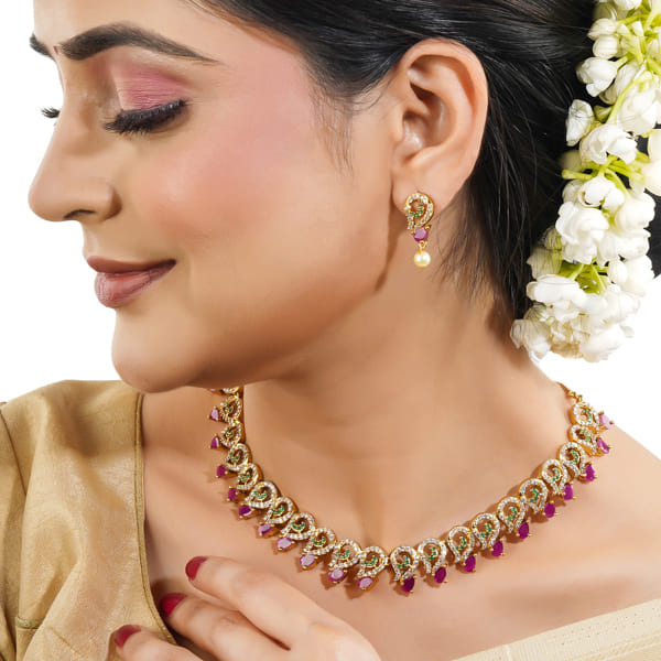 Vibrant multicolor stone-studded goldtone necklace set with matching earrings for festive elegance.
