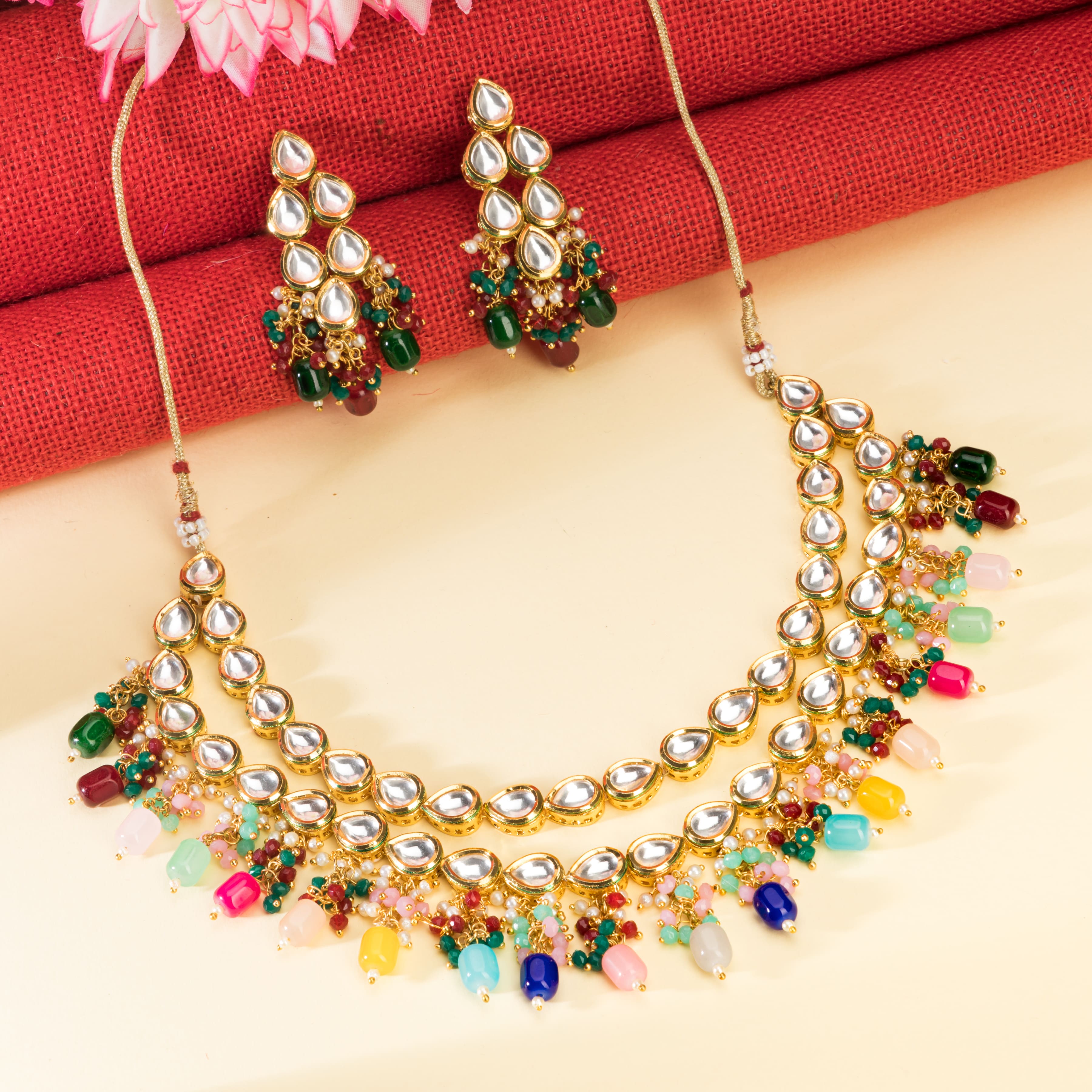 "Elegant double-layer Kundan necklace set with multicolor pearls, perfect for a vibrant festive look."
