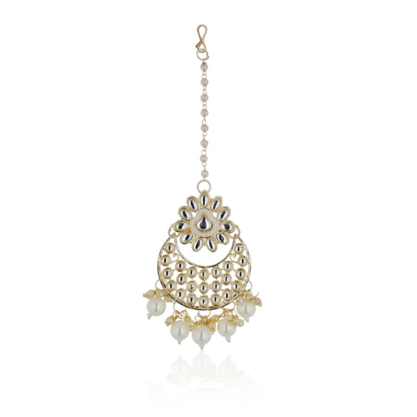 "Classic silver Kundan and pearl-studded earrings with matching Maang Tikka for festive elegance."
