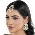"Classic silver Kundan and pearl-studded earrings with matching Maang Tikka for festive elegance."
