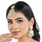 "Festive Kundan and multicolor pearl earrings with matching Maang Tikka, offering an elegant look."
