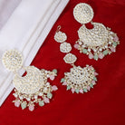 "Multicolor Kundan and pearl earrings with Maang Tikka, perfect for a classic festive style."
