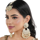 "Multicolor Kundan and pearl earrings with Maang Tikka, perfect for a classic festive style."
