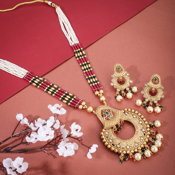 "Classic goldtone long necklace set with matching earrings for a festive, elegant look."
