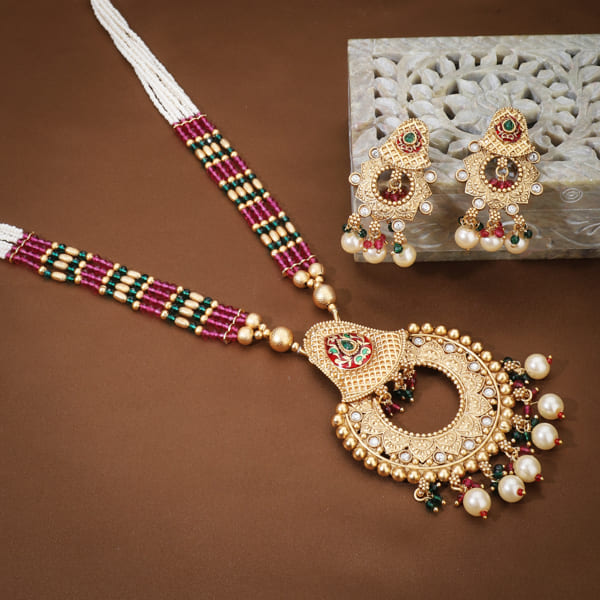"Classic goldtone long necklace set with matching earrings for a festive, elegant look."
