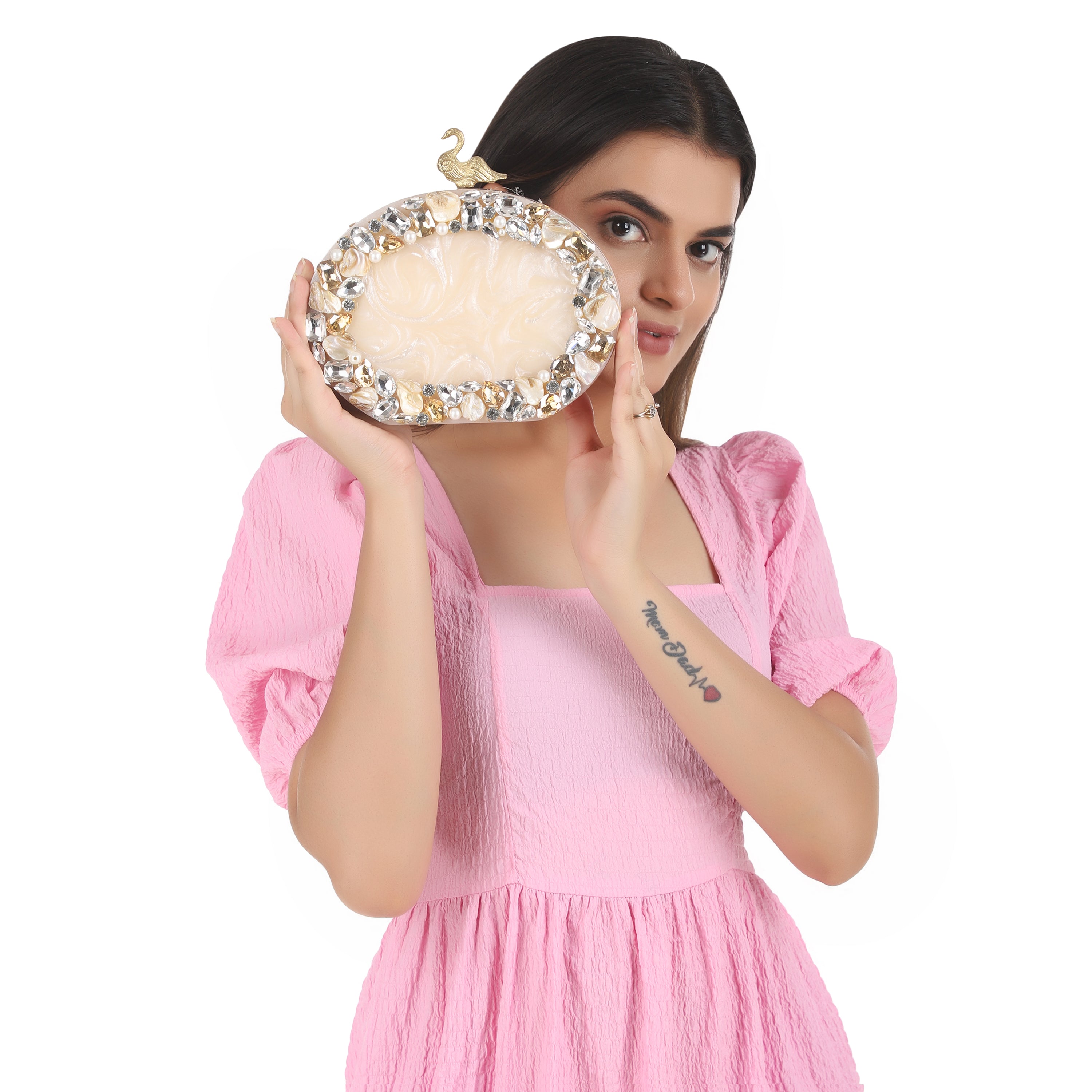Oval-shaped salmon resin clutch with peacock design closure and sleek sling chain for style.
