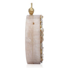 Oval-shaped salmon resin clutch with peacock design closure and sleek sling chain for style.
