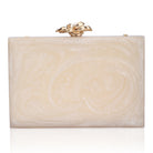 Embellished salmon resin clutch with extra pocket and sturdy sling for a chic and convenient style.
