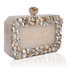 Resin-embellished salmon clutch with rose knob, sturdy sling, and extra pocket for convenience.
