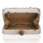Resin-embellished salmon clutch with rose knob, sturdy sling, and extra pocket for convenience.
