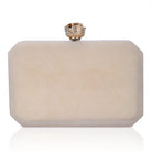 Resin-embellished salmon clutch with rose knob, sturdy sling, and extra pocket for convenience.

