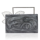 Exclusive grey resin clutch with flower handles, heavy sling, and extra pocket for practicality.
