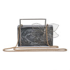 Exclusive grey resin clutch with flower handles, heavy sling, and extra pocket for practicality.
