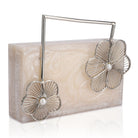 Salmon resin clutch with unique flower handles, heavy sling, and extra pocket for convenience.
