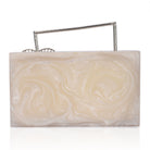 Salmon resin clutch with unique flower handles, heavy sling, and extra pocket for convenience.
